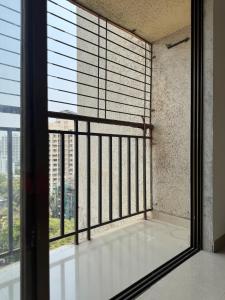 an empty room with a large window with blinds at Home Sweet Home in Thane