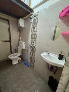 a bathroom with a sink and a toilet and a mirror at Home Sweet Home in Thane +9 photos