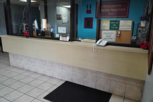 a cashier counter in a store with a sign in the window at Richmond - Quality Quarters Inn in Richmond
