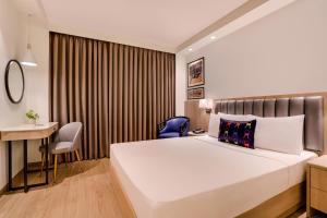 Posteľ alebo postele v izbe v ubytovaní Keys Prima by Lemon Tree Hotels, Pimpri, Pune