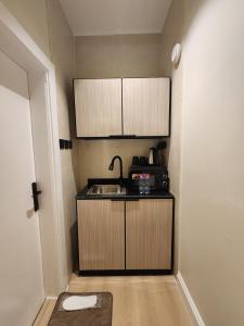 a small kitchen with a sink and a microwave at ComfyStay KSA - Boho-Chic Studio Near Cafés in Riyadh