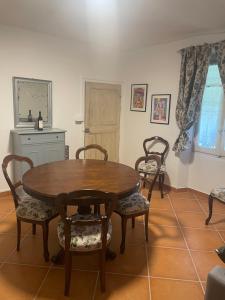 a dining room with a wooden table and chairs at Cascina Valgrande, Monferrato in Carpeneto