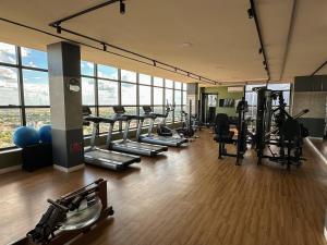 a gym with a row of treadmills and machines at Apartamento Sunset Residence 1208 in Dourados