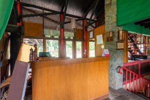 a bar in a building with windows and a counter at Capital O 2640 Cottage GS Rumah Kayu Syariah in Batureo 1 +19 photos