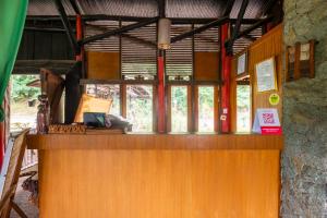 a counter in a building with a window at Capital O 2640 Cottage GS Rumah Kayu Syariah in Batureo 1