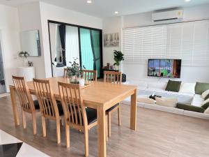 a living room with a wooden table and chairs at V Villa Khaoyai in Ban Nong Ka Cha