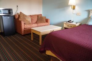 a hotel room with a bed and a couch at Richmond - Quality Quarters Inn in Richmond