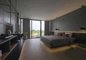 a bedroom with a bed and a large window at Chuỗi Villa 6 ngủ Siêu VIP Tuần Châu S-H - Mặt Biển - View vịnh in Ha Long +12 photos