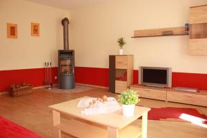 a living room with a stove and a table at Ferienwohnung Brigatt in Klotten