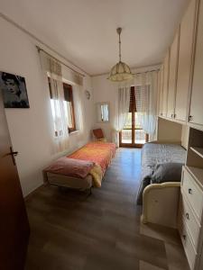 a bedroom with two beds and a couch in it at Magic Living Home in Campora San Giovanni