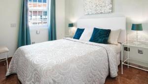 a bedroom with a white bed and a window at GORGEOUS VIEW Villa & Sauna, Golf Costa Adeje in Adeje +36 photos