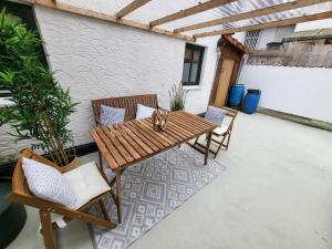 a wooden table and chairs on a patio at Fachwerkstube in Witzenhausen