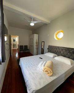 a bedroom with a bed with two towels on it at Pousada Madalena in Sao Paulo