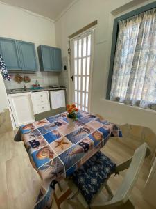 a kitchen with a table with a table cloth on it at Costa relax in Costa Rei +10 photos