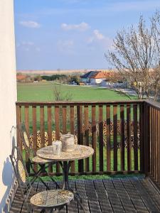 a table on a balcony with a table on a bench at Appartement Sonnblick in Breitenbrunn +12 photos