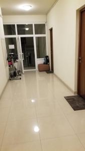 a living room with a white tile floor and a door at Apartment and Private Office in Yerevan