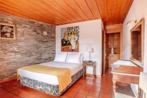 a bedroom with a bed and a piano at Casa da Joana in Mirandela +24 photos