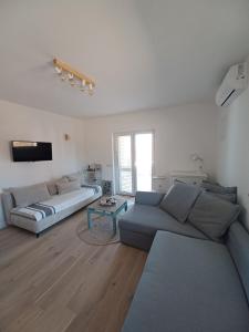 a living room with a couch and a table at Apartment Dry dock in Postira