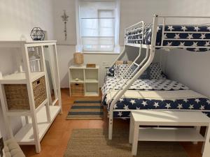 a kids room with a bunk bed and a ladder at Bellamar Playa Santa Maria in Naveces