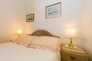 a bedroom with a bed and two lamps on a nightstand at Shoreline Accommodation in Bournemouth