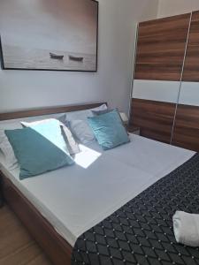 a bed with two pillows on it in a bedroom at Villa Tea in Murter