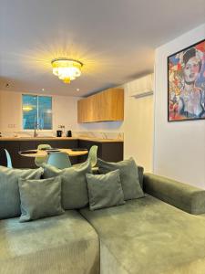 a living room with a couch and a kitchen at CANNES Maison Design "DOLCE VITA" in Cannes
