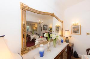 a room with a mirror and a table with flowers at Shoreline Accommodation in Bournemouth