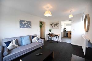 a living room with a couch and a table at 2bed Cowgate next Newcastle Golf Club Free Parking in Kenton