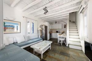 a living room with a couch and a table at Paros 3 bedrooms Maisonette for 6 persons by MPS in Molos Parou