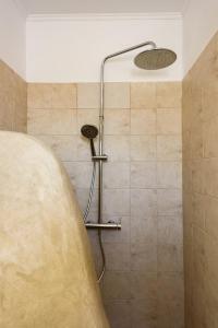 a shower in a bathroom with a tub at Paros 3 bedrooms Maisonette for 6 persons by MPS in Molos Parou
