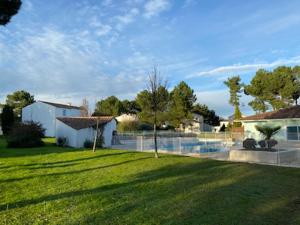 a yard of a house with a grass field at la belle cascade 2 in Dolus-d'Oléron