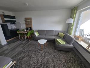 a living room with a couch and a table at 1 Zimmer Wohnung Laatzen nähe Messe in Hannover