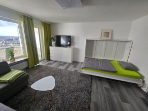 a bedroom with a large bed and a couch at 1 Zimmer Wohnung Laatzen nähe Messe in Hannover