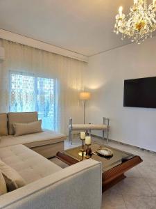 a living room with a couch and a tv at City Center Luxury Spacious apt A&M II in Rhodes Town +54 photos