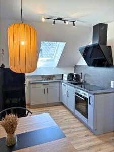 a kitchen with a stove and a table and a window at Apartment Ikigai in Cochem