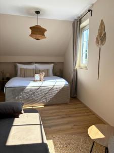 a bedroom with a bed with a cat sitting on it at Apartment Ikigai in Cochem