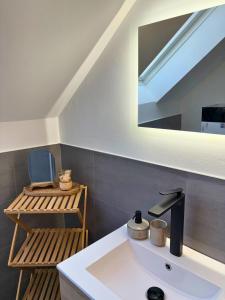 a bathroom with a sink and a mirror at Apartment Ikigai in Cochem