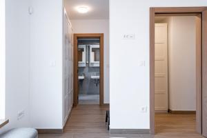 a hallway with a door leading into a bathroom at Novi Sad's Quiet Quarters in Novi Sad +19 photos