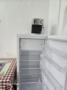 a white refrigerator with a toaster on top of it at Rózsa Panzió in Rimetea +13 photos