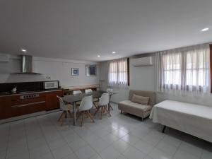 a room with a kitchen and a bed and a table and chairs at Hotel Capri in Tossa de Mar