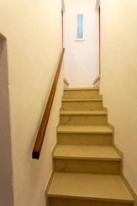 a staircase in a house with a picture on the wall at La casina di Bianca in Volterra