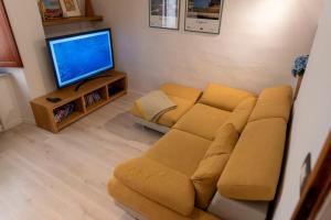 a living room with a couch and a television at La casina di Bianca in Volterra