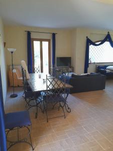 a living room with a table and chairs and a couch at Villa Eliana Fregene in Fregene