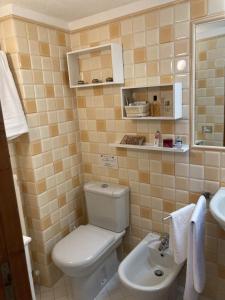 a bathroom with a toilet and a sink at Sogni d'Oro Spello in Spello +16 photos