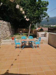 a table and four chairs on a patio at O Muiño do Torneiro in A Pobra do Caramiñal