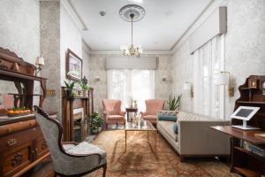 a living room with a couch and a chair at The Mason Cottage Downtown in Cape May