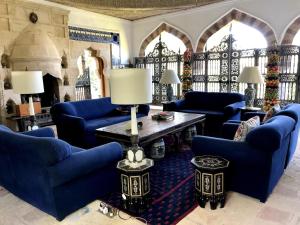 a living room with blue couches and a table at Dream House by the Aegean Coast in Dikili