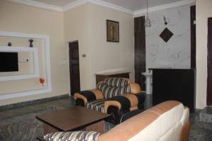 un soggiorno con due divani e una TV di Adbates Suites and Recreation a Oshogbo