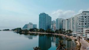 a city with tall buildings next to a body of water at Tranquila y cerca de la magia in Cartagena de Indias