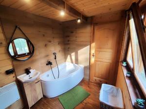 a bathroom with a tub and a sink and a mirror at Wypoczynek "POD BRZÓSTKAMI" in Nagłowice +35 photos